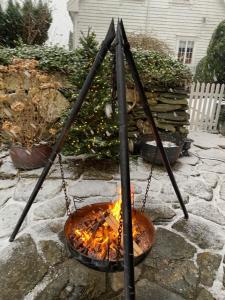 a fire in a pot on a stone patio at Eldhuset in Stavanger