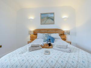 a bedroom with a large bed with two pillows at Dunnock - Uk50146 in Faversham