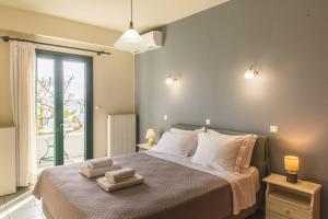 a bedroom with a bed with two towels on it at Gorgones, sea-front, great view in Kardamyli
