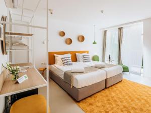 a bedroom with a large bed and a ladder at ibis Styles Golden Sands Roomer Hotel in Golden Sands +63 photos