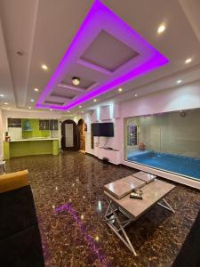 a living room with a swimming pool and purple lighting at مؤسسة مطلة الورد Matallat Alward Est in Taif
