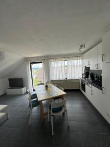 a kitchen with a table and chairs in a room at Ferienhaus Talblick in Kelberg