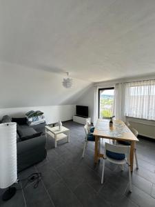 a living room with a table and a couch at Ferienhaus Talblick in Kelberg