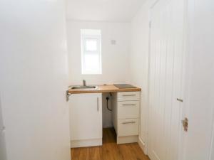 a small kitchen with a sink and a window at Hedgehog Lodge in Chorley +10 photos