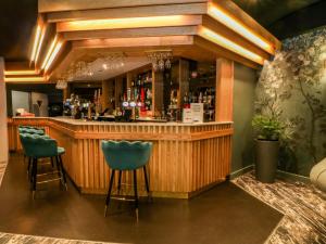 a bar with two blue bar stools in a room at Hedgehog Lodge in Chorley