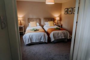 a bedroom with two beds and two lamps at Charming St Davids Cottage with Cathedral Views in St. Davids