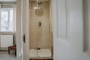 a bathroom with a shower with a sink in it at Charming St Davids Cottage with Cathedral Views in St. Davids +48 photos