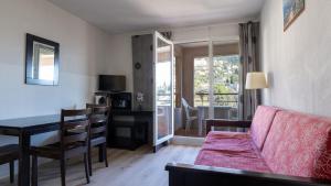 a living room with a couch and a table and a dining room at Virginia N 202 2P4 in Grasse
