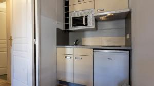 a kitchen with a sink and a microwave at Virginia N 202 2P4 in Grasse