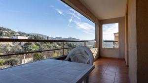 a balcony with a table and a view of the mountains at Virginia N 202 2P4 in Grasse