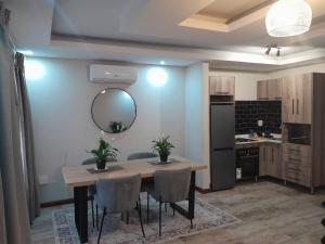 a kitchen with a table and chairs and a mirror at Magnolia Hotel in Middelburg