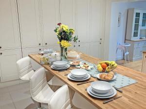 a table with plates and bowls of food on it at Riverside in Wimblington +31 photos