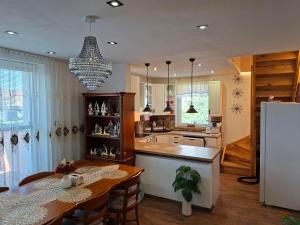 a kitchen with a dining table and a refrigerator at Vila Vannet II in Liptovský Mikuláš