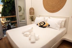 a bedroom with a bed with towels on it at Aidani Luxurious Rooms in Vóthon