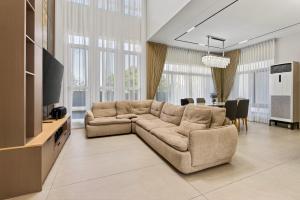 a living room with a couch and a dining room at Luxury House with Private Pool for Gathering in Davao City