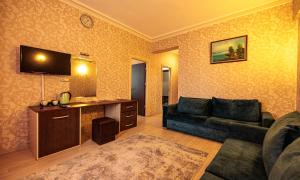 a living room with a couch and a table at Divaisib Termal Resort Hotel & Spa in Kozaklı