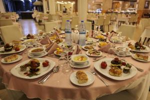 a table with plates of food and bottles of water at Divaisib Termal Resort Hotel & Spa in Kozaklı