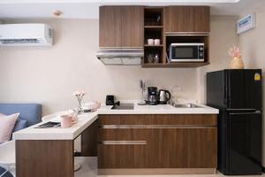 a small kitchen with a sink and a refrigerator at KAI Condo 1BR Pool View NBC Nai Harn in Rawai Beach +12 photos