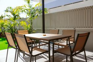 a wooden table and chairs on a patio at Chaba Pool Villa Khao Lak in Khao Lak
