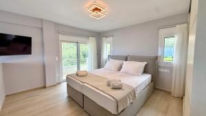 a bedroom with a bed with two towels on it at Villa Palomar in Kyparissia +46 photos