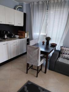 a kitchen and dining room with a table and a couch at Апартамент Лана 2 in Byala