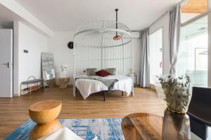a bedroom with a bed and a table at Yumian Cloud Seaview Hotel in Sanya