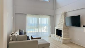 a living room with a couch and a fireplace at Villa Palomar in Kyparissia