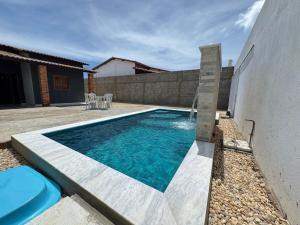a swimming pool in the backyard of a house at Casa em Tibau in Tibau