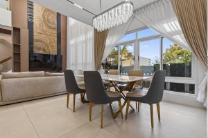 a dining room with a glass table and chairs at Luxury House with Private Pool for Gathering in Davao City