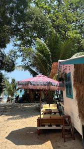 a table and an umbrella on a beach at Benny beach house in Ko Samed