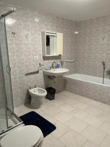 a bathroom with a toilet and a sink and a shower at Casa Maggini in Ancona