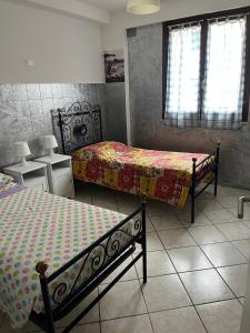 a bedroom with two beds and a window at Casa Maggini in Ancona