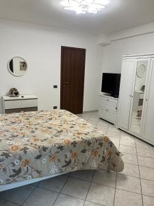 a bedroom with a bed and a flat screen tv at Casa Maggini in Ancona