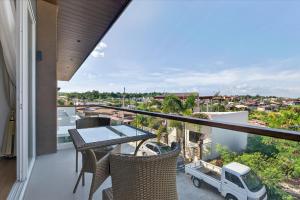 a balcony of a house with a table and chairs at Luxury House with Private Pool for Gathering in Davao City