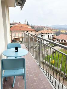 a table and chairs on a balcony with a view at Quick Home Belvedere Masserano in Masserano