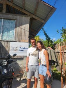 a man and a woman standing next to a motorcycle at Little Zabina Inn in San Juan +7 photos