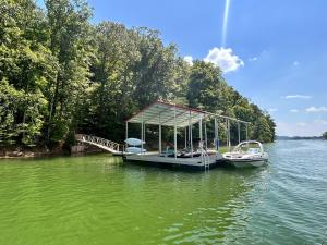 a boat is docked at a dock in the water at Tranquility Cove Lodge in Dandridge