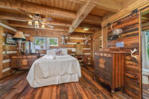 a bedroom with a bed in a room with wooden walls at Tranquility Cove Lodge in Dandridge