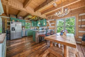 a kitchen with green cabinets and a wooden floor at Tranquility Cove Lodge in Dandridge