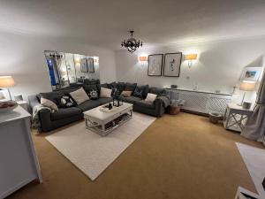a living room with a couch and a table at Beach House Manningtree in Manningtree
