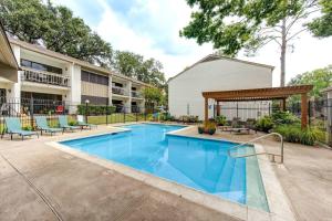 a swimming pool with a gazebo next to a building at Lakefront Action Paddle Pickle Pool Sunset in Montgomery
