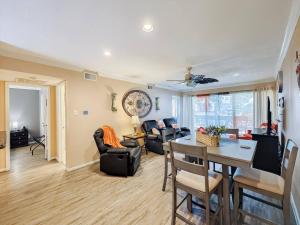a living room with a table and a dining room at Lakefront Action Paddle Pickle Pool Sunset in Montgomery