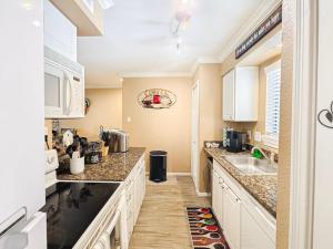 a kitchen with a sink and a counter top at Lakefront Action Paddle Pickle Pool Sunset in Montgomery