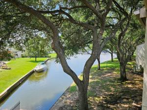 a boat on a river with a tree at Lakefront Action Paddle Pickle Pool Sunset in Montgomery