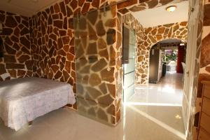 a room with a stone wall with a bench in it at Villa Brownies in Els Poblets +22 photos