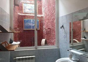 a bathroom with a window and a sink and a toilet at Al Palmento in Galati Mamertino +33 photos