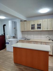 a large kitchen with a island in the middle at Perla Sarisorului in Sărişor