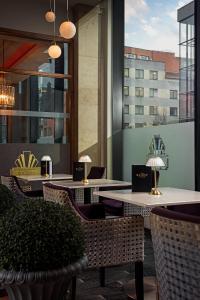 a restaurant with tables and chairs and a large window at The Savoy Hotel in Limerick