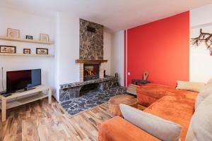 a living room with a couch and a fireplace at Vilka Cibulka a chata Cesnačik in Ižipovce