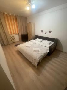 a bedroom with a large bed with two towels on it at Garsoniera in Bacău